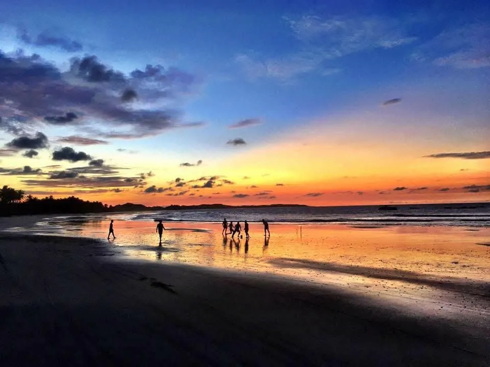 Sunset football on the beach at low tide